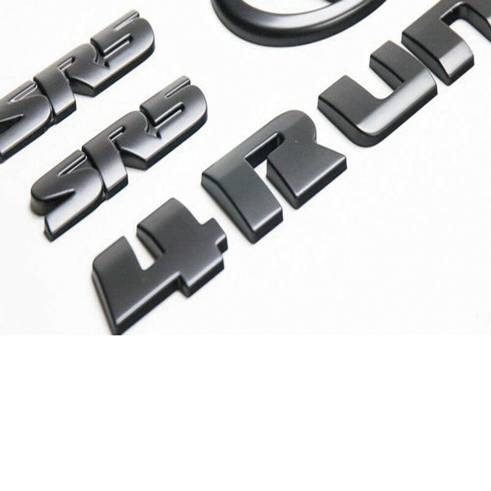 Black Toyota 4Runner emblem kit including two SR5 badges, two Toyota oval logos, and a set of '4Runner' letters.