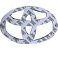 Back side of a black Toyota emblem with 3M adhesive tape