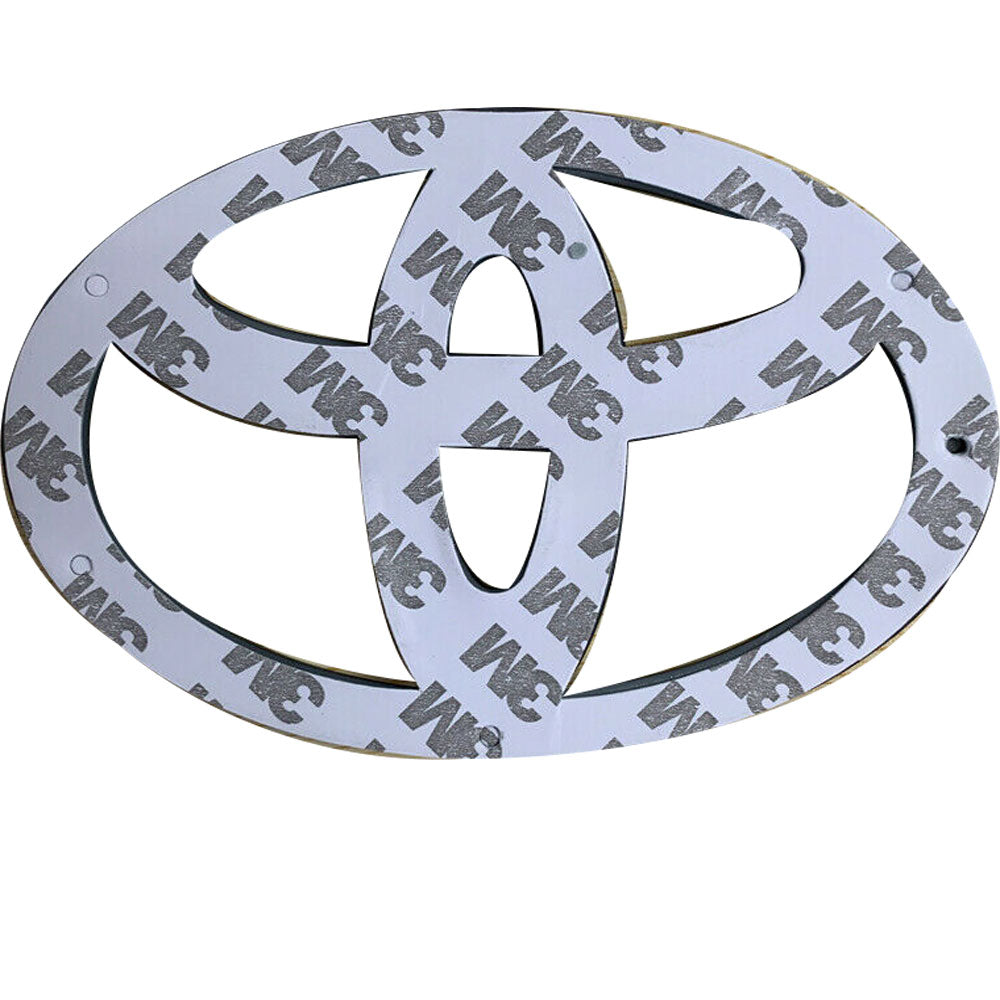 Back side of a black Toyota emblem with 3M adhesive tape