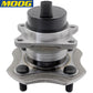 MOOG wheel hub assembly with ABS sensor, placed in front of a yellow MOOG branded box, automotive replacement part.


