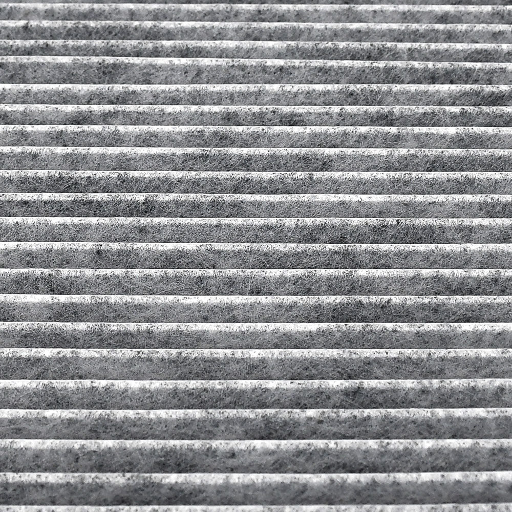 Cabin air filter C25858 with activated carbon pleated media, white frame labeled "MADE IN CHINA AIR FLOW" with directional arrow.

